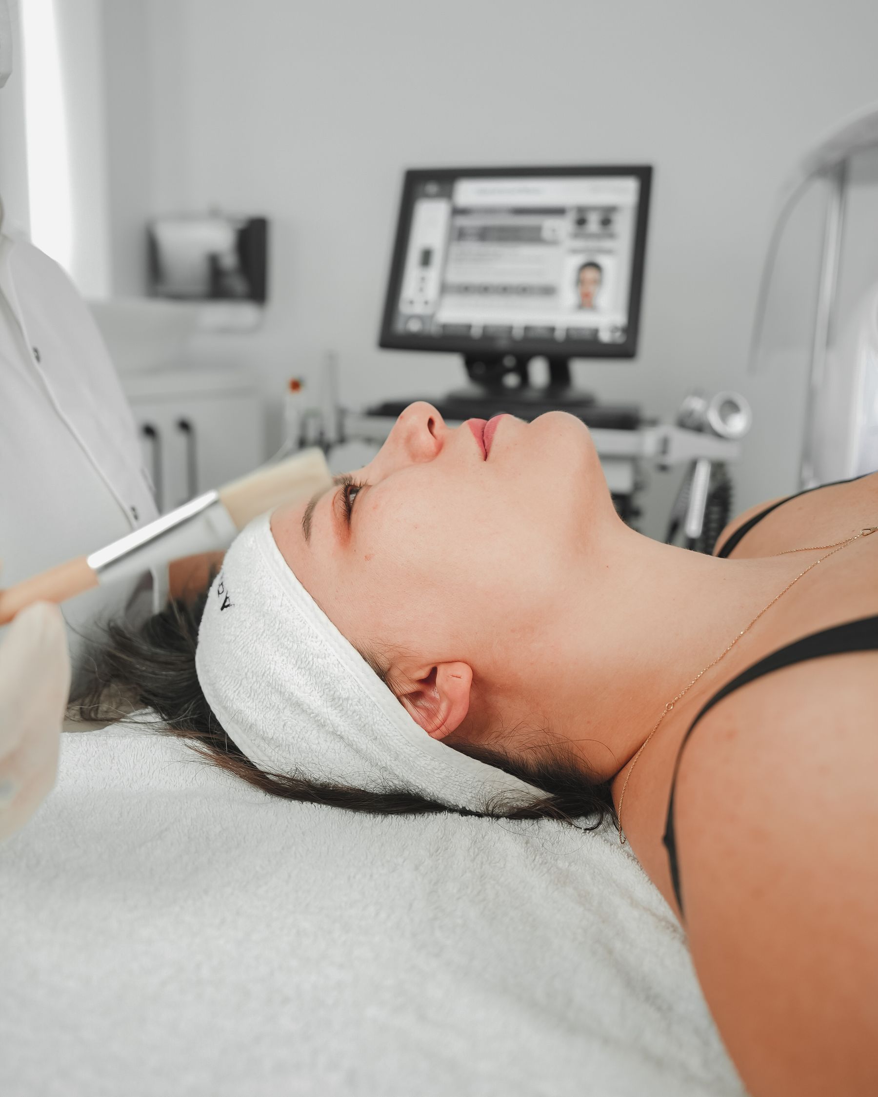 Client on a facial treatment bed