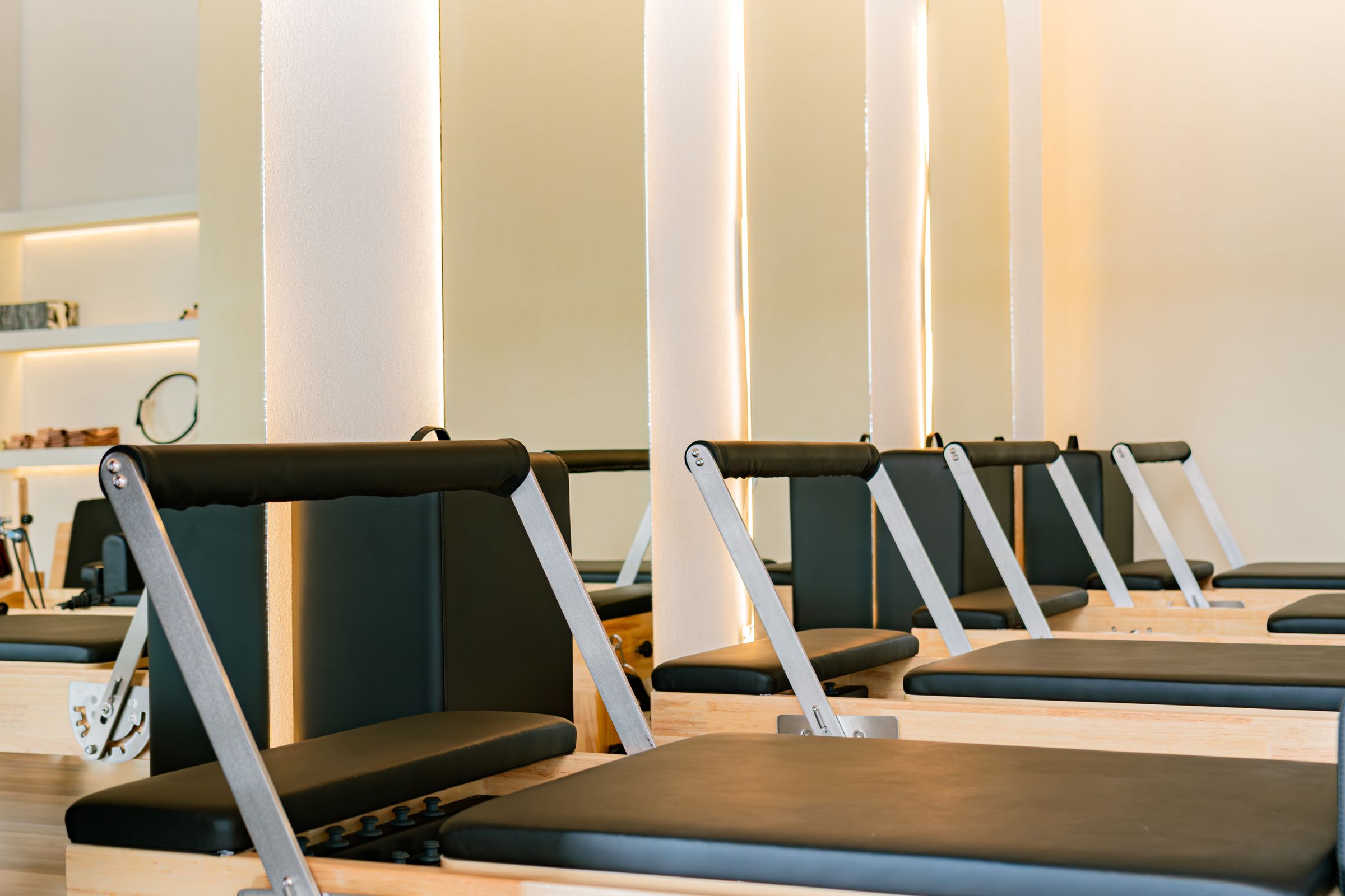 Calm Pilates studio with a row of reformers