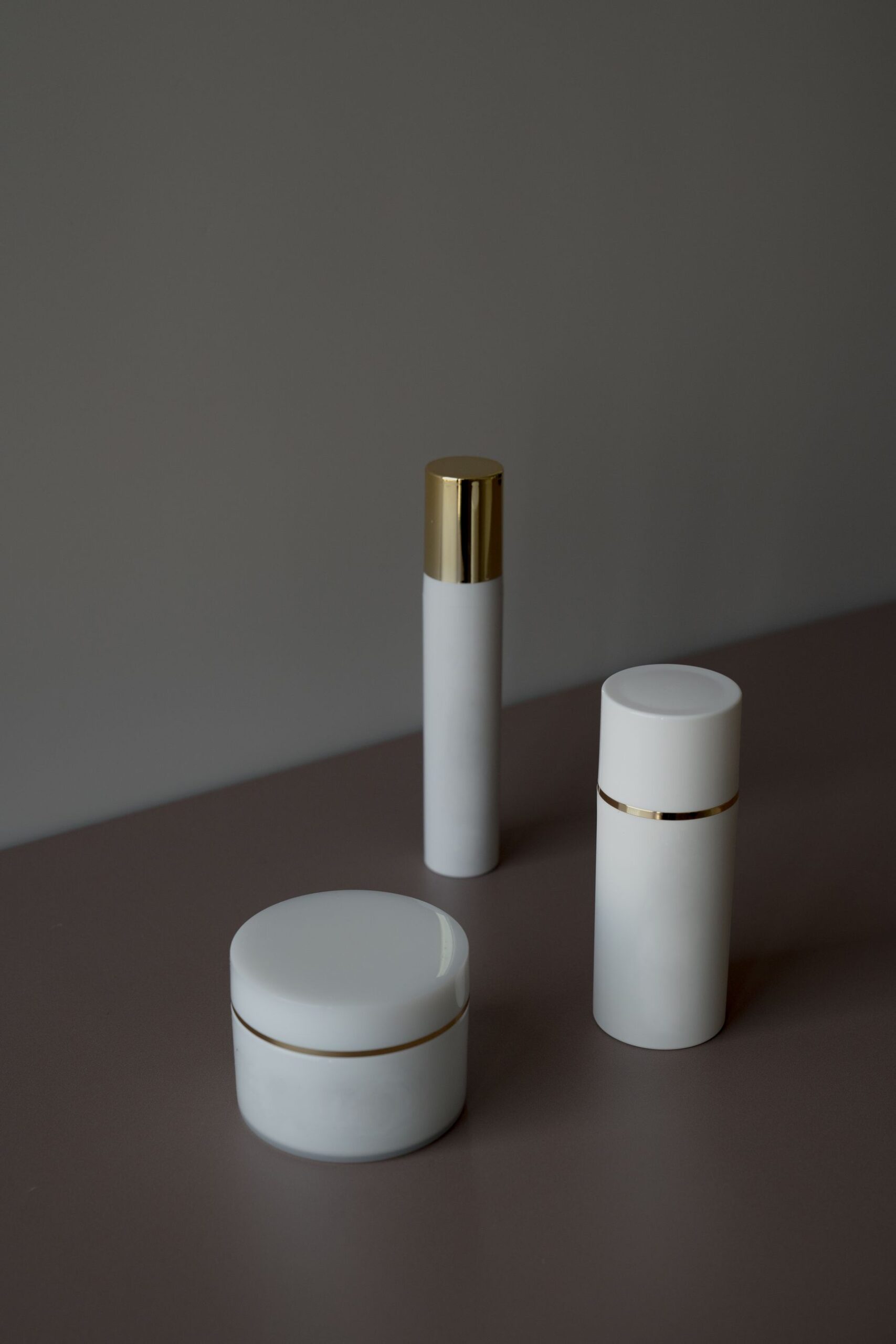 Skincare bottles in soft shadow