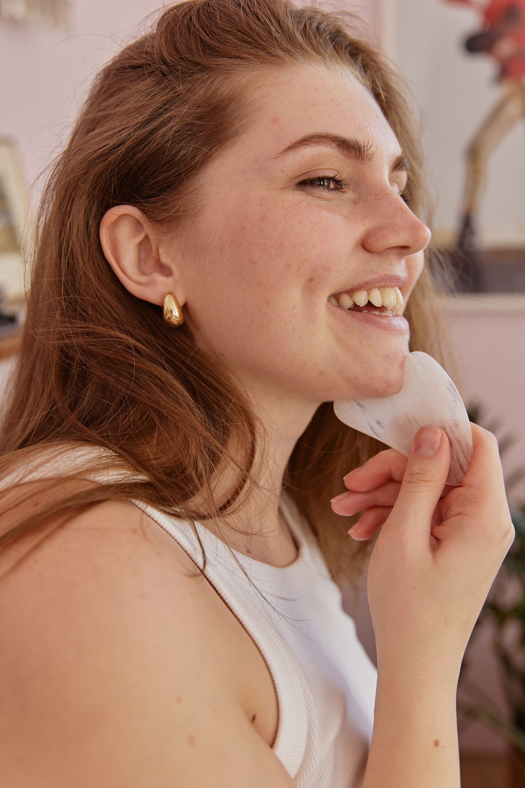 Woman using a gua sha stone