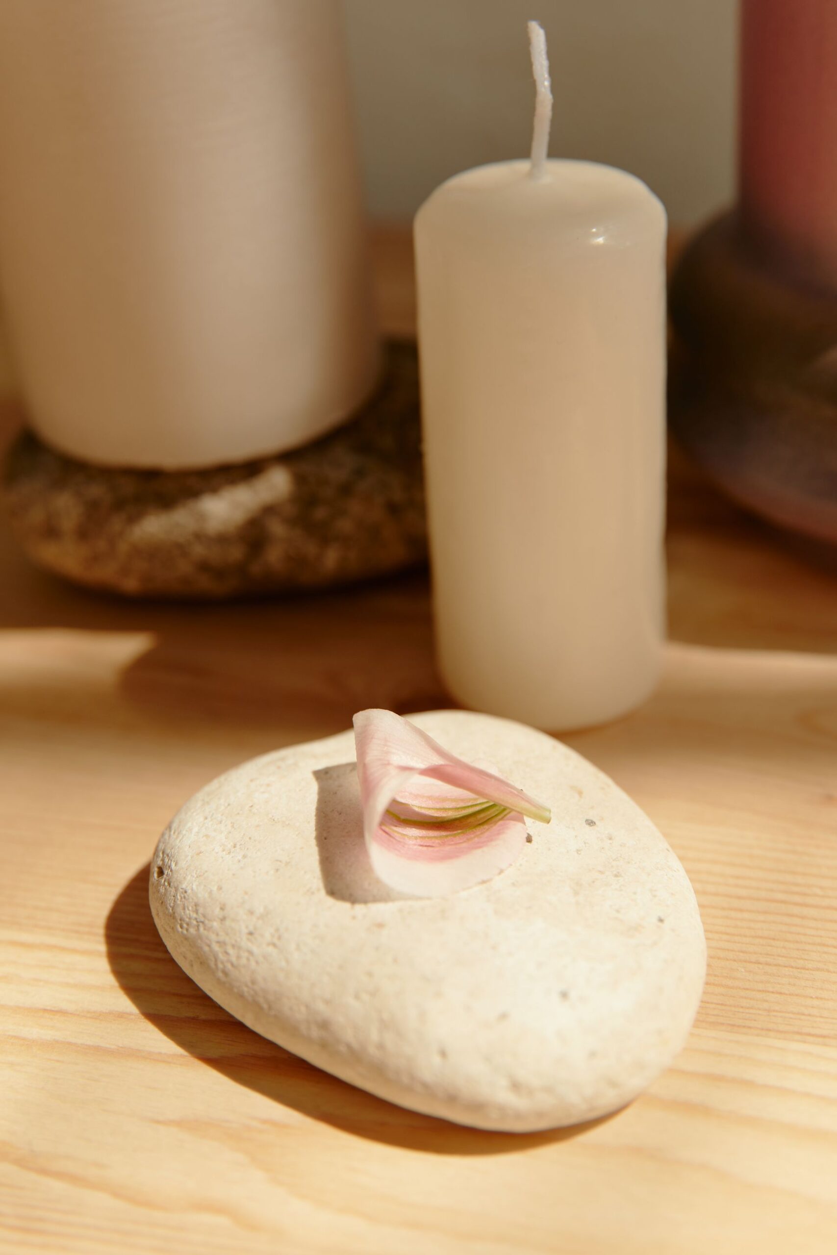 Candle beside a stone